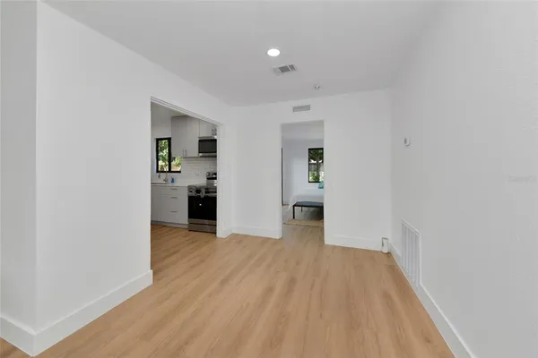 a view of a kitchen with a sink and a refrigerator