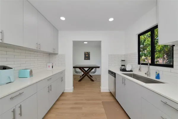 a kitchen with a sink and wooden cabinets