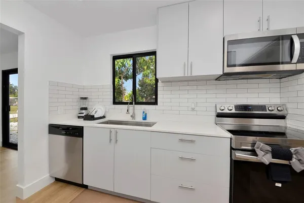 a kitchen with a sink and cabinets