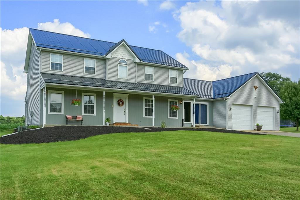 503 Dick Road Butler, PA 16001 - Photo 1 of 27 a view of a white house with a big yard and potted plants