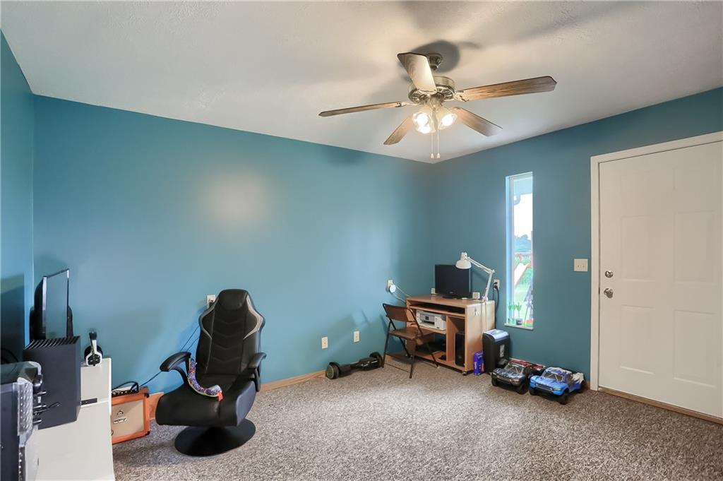 503 Dick Road Butler, PA 16001 - Photo 14 of 27 a room with gym equipment and a chandelier fan