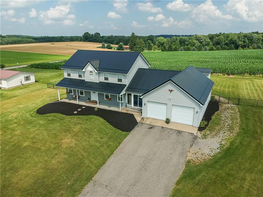 503 Dick Road Butler, PA 16001 - Photo 3 of 27 an aerial view of a house with a garden and lake view