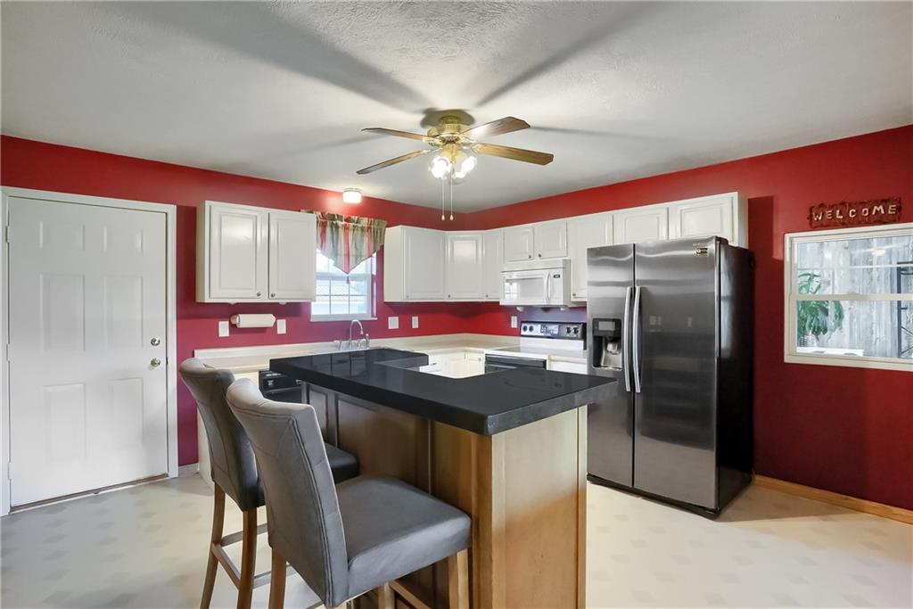 503 Dick Road Butler, PA 16001 - Photo 7 of 27 a kitchen with stainless steel appliances granite countertop a dining table chairs refrigerator and cabinets