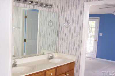 8401 Waynesboro Court Raleigh, NC 27615 - Photo 4 of 10 a bathroom with a sink and a mirror