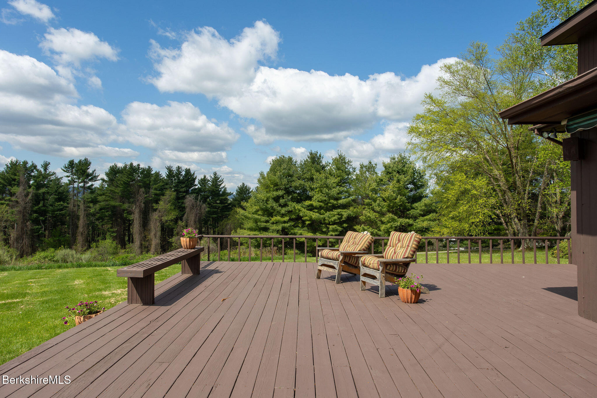 77 Hurlburt Road Great Barrington, MA 01230 - Photo 45 of 48 a view of a deck with a table and chairs with wooden floor and fence