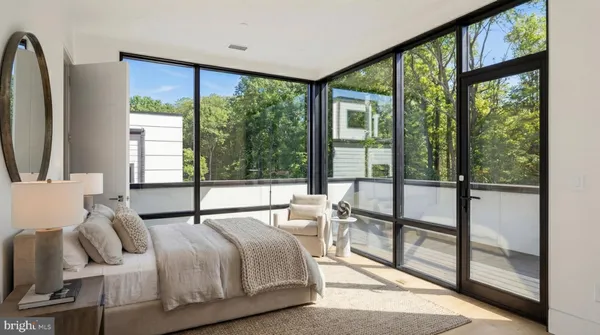 a living room with furniture a fireplace and a large window