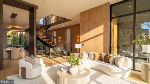 a living room with fireplace furniture and a large window