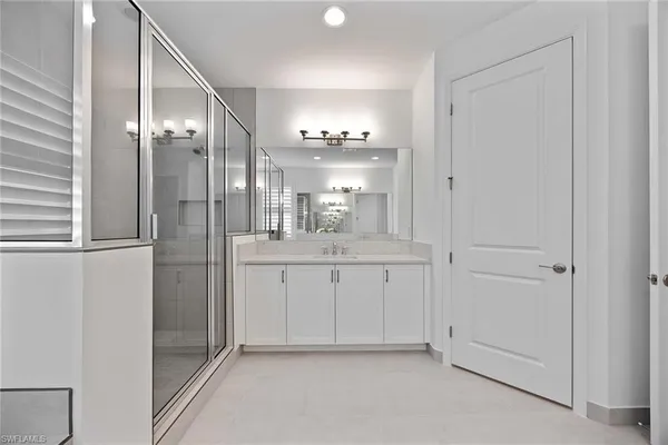 a bathroom with a mirror and a shower