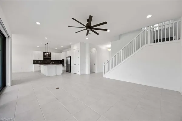 a view of a kitchen with a sink and a ceiling fan