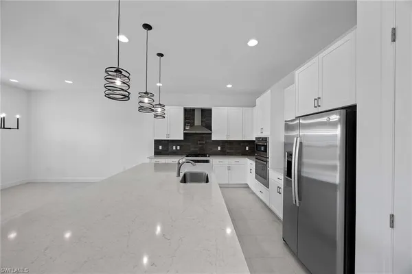 a kitchen with refrigerator and window