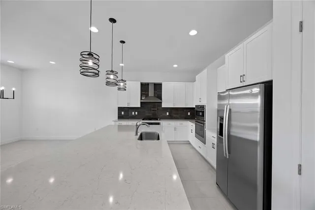 a kitchen with refrigerator and window