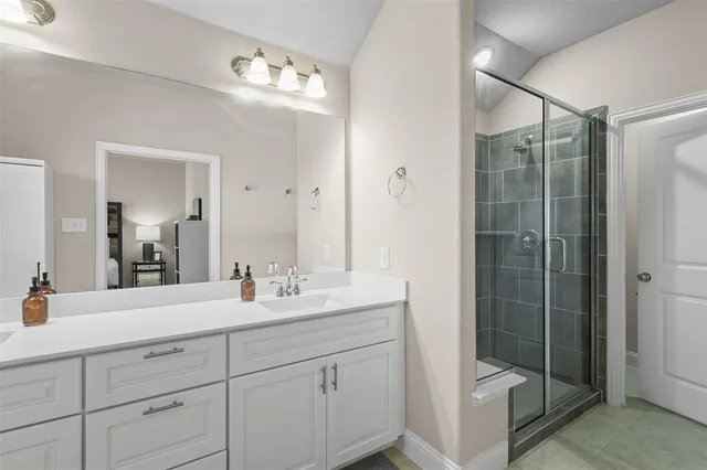 a bathroom with double sink and mirror
