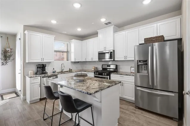 a kitchen with a refrigerator a stove a sink and a refrigerator
