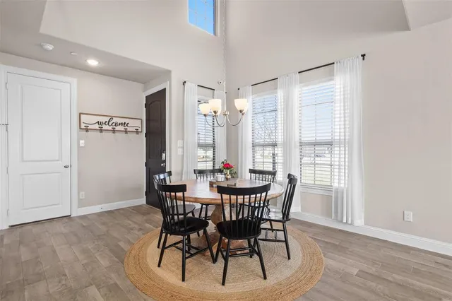 a view of a dining room with furniture and window