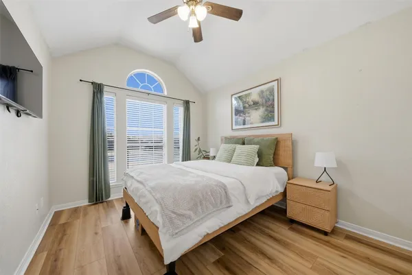 a bedroom with a bed and a large window