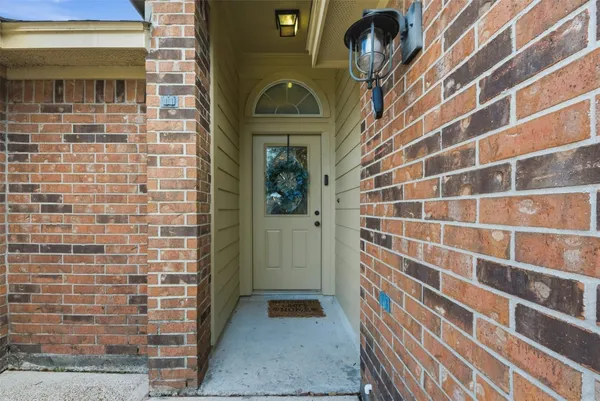 a view of a door and brick walls