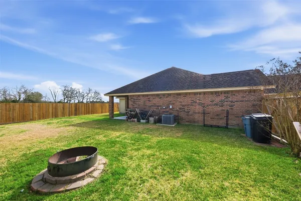 a view of a backyard with a barbeque grill and a lake view