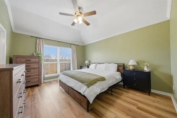 a spacious bedroom with a bed and a chandelier