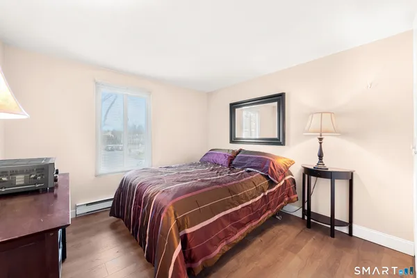a bed sitting in a bedroom next to a window
