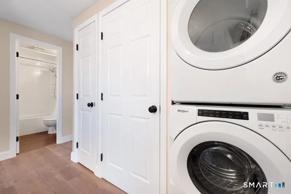 a view of a hallway with washer and dryer