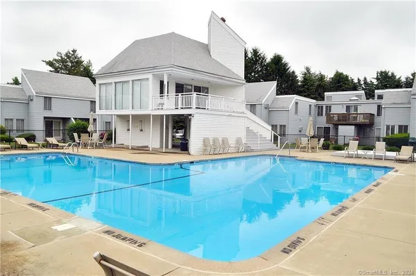a view of a swimming pool with outdoor seating
