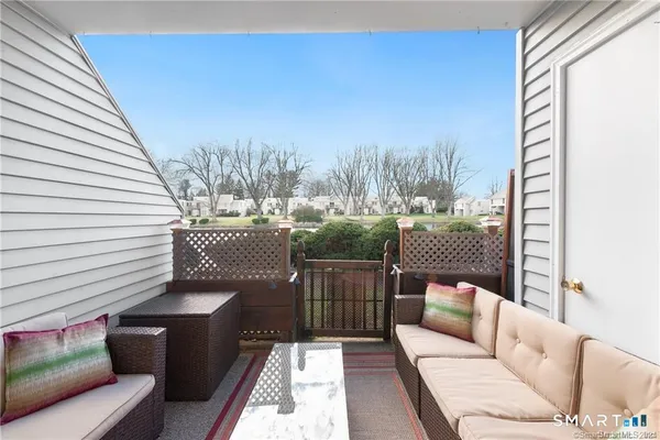 a balcony with furniture and a potted plant
