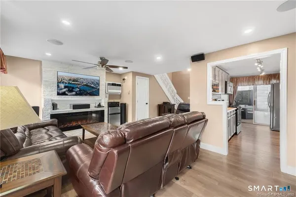 a living room with furniture and wooden floor