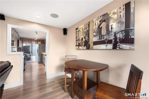 a view of a dining room with furniture and wooden floor
