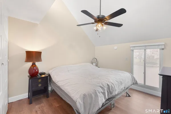 a bedroom with a bed and a ceiling fan