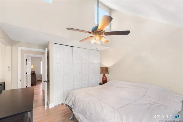 a bedroom with a bed and a ceiling fan