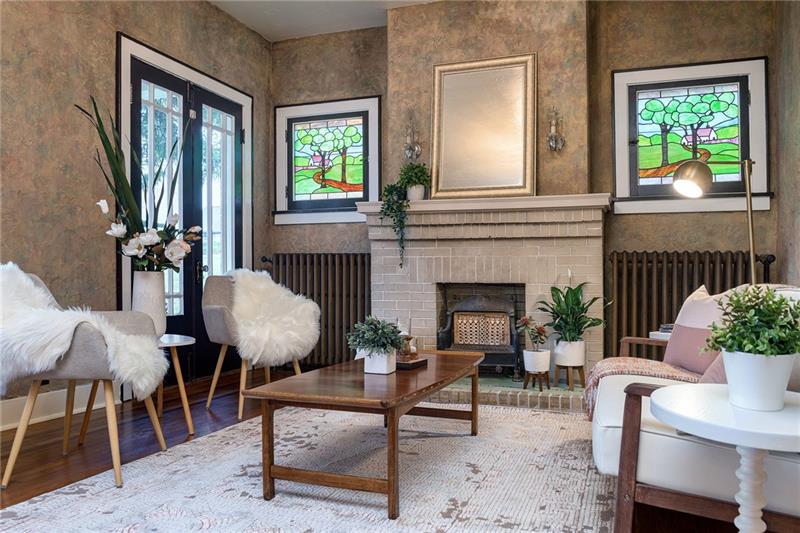 300 Forest Grove Road Coraopolis, PA 15108 - Photo 7 of 25 Gas fireplace with stained glass windows featured on either side.