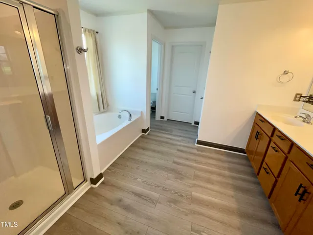 a bathroom with a tub and a shower