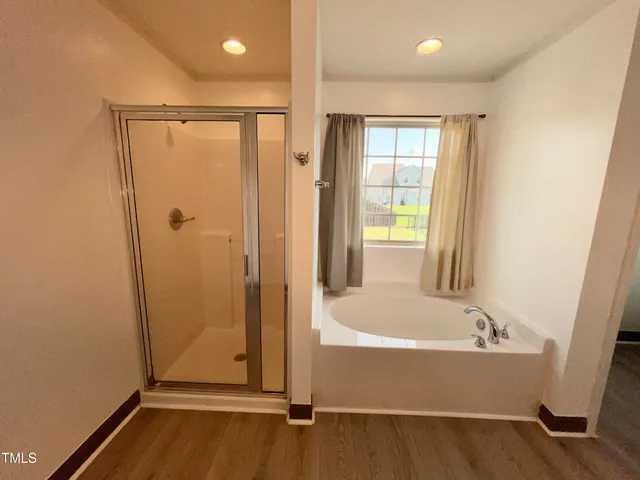 a view of walk in closet with clothes