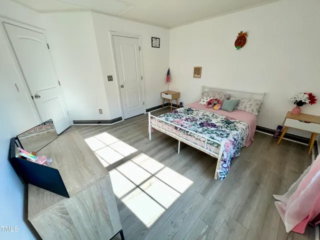 a bedroom with a bed and a dresser