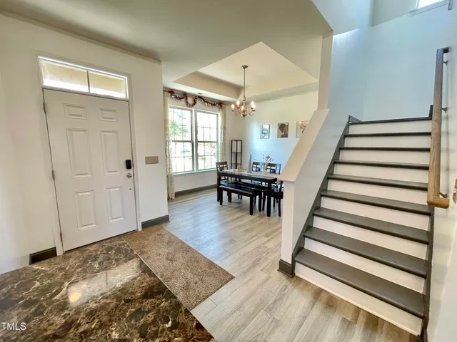 a view of entryway dining room and hall with wooden floor