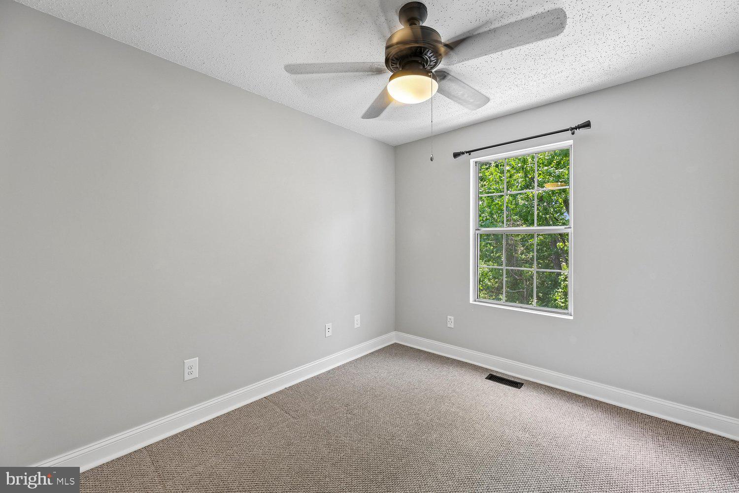 15764 Beau Ridge Drive Woodbridge, VA 22193 - Photo 32 of 58 an empty room with a window and a chandelier fan