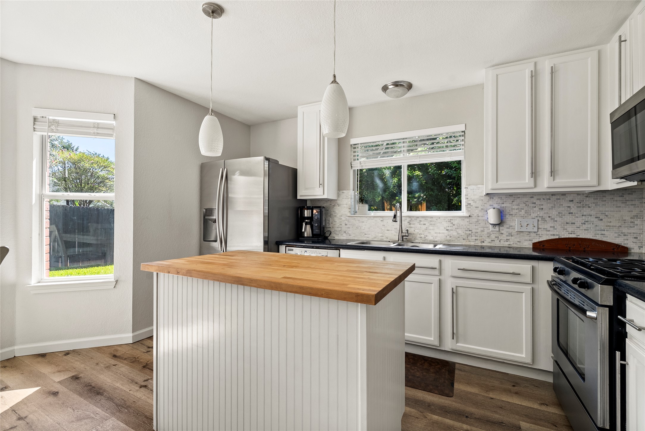 9024 Heiden Lane Austin, TX 78749 - Photo 15 of 33 The updated kitchen features a central island topped with a butcher block countertop, offering a natural focal point for prep work or casual conversation