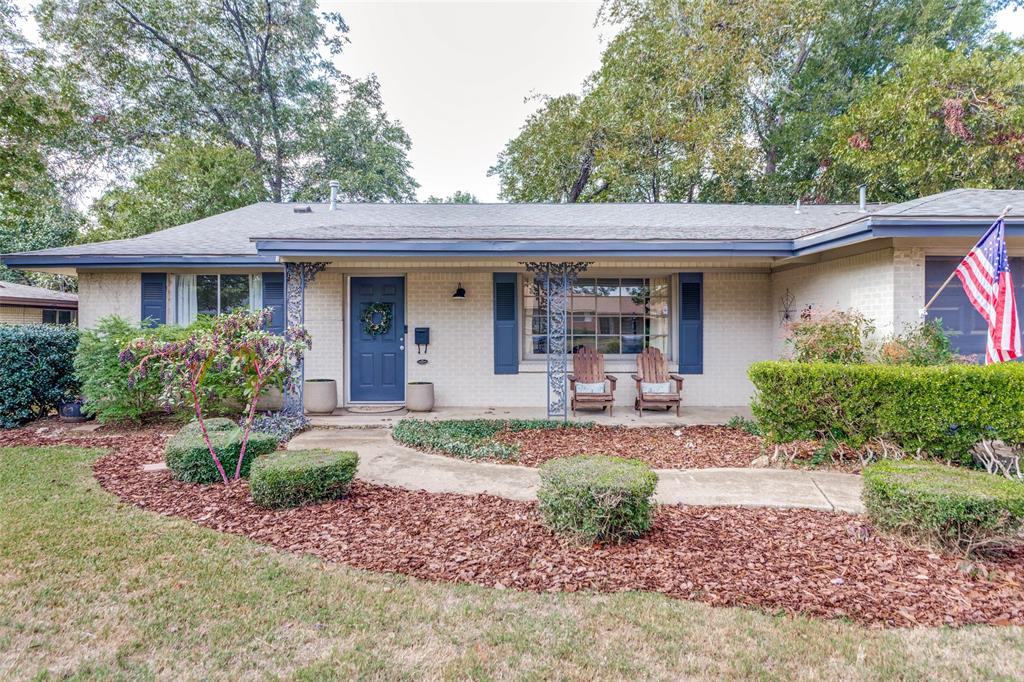 Single story home featuring a porch and brick siding