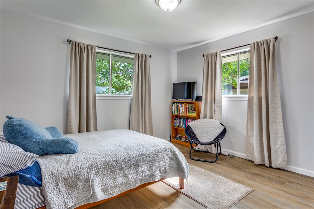 6921 Valhalla Road Fort Worth, TX 76116 - Photo 19 of 25 Bedroom with wood finished floors and multiple windows