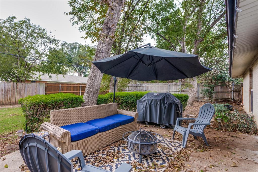 6921 Valhalla Road Fort Worth, TX 76116 - Photo 22 of 25 Fenced backyard with grilling area, a patio area, and an outdoor fire pit