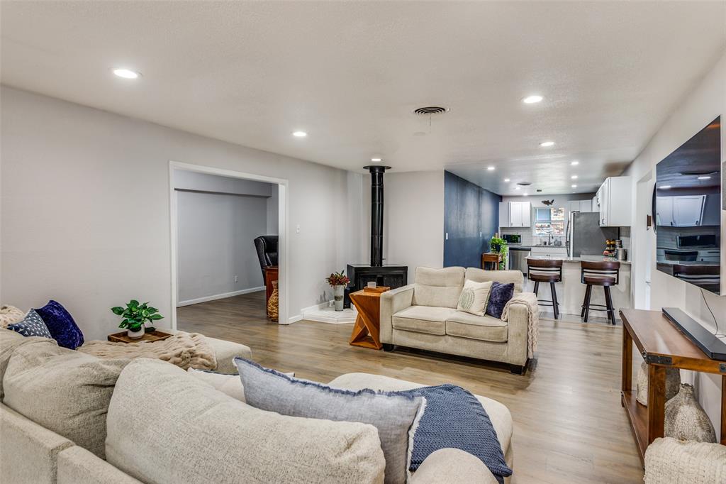 6921 Valhalla Road Fort Worth, TX 76116 - Photo 6 of 25 Living area with a wood stove, recessed lighting, and light wood finished floors