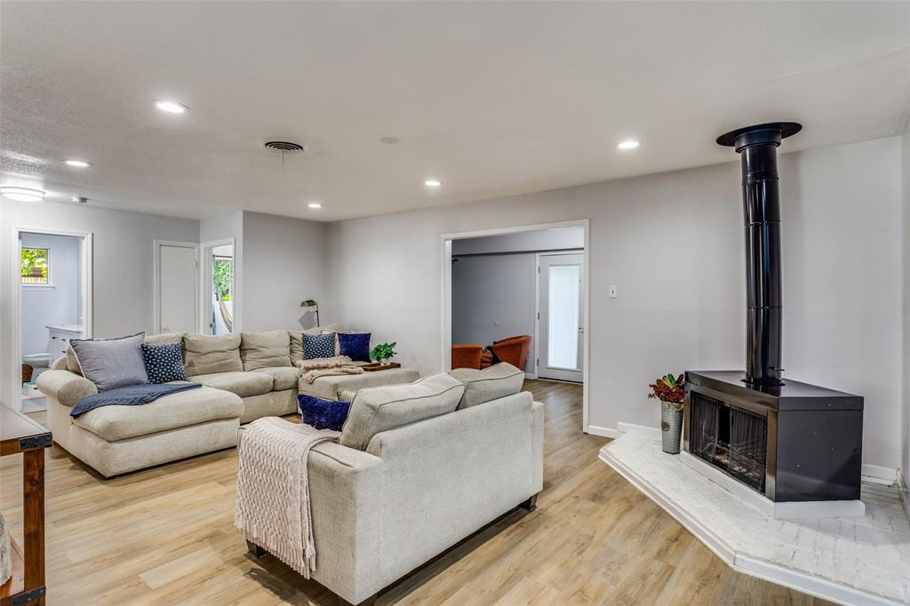 6921 Valhalla Road Fort Worth, TX 76116 - Photo 8 of 25 Living area with a wood stove, light wood-style flooring, and recessed lighting