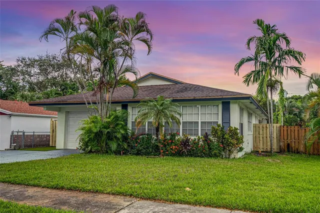 a couple of palm trees in front of house