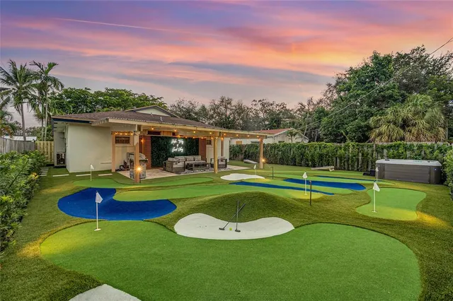 a view of a house with swimming pool and a yard