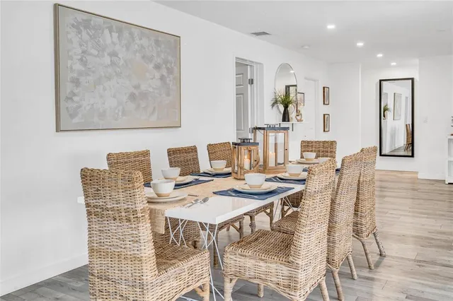 a dining room with furniture and wooden floor