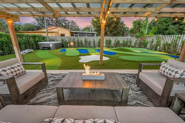 a view of a backyard with couches table and chairs