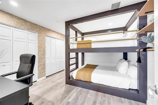 a bedroom with a bed a desk and chair