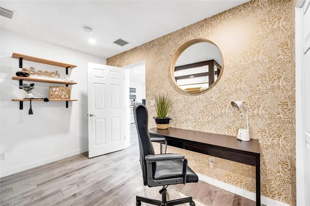 a view of workspace with wooden floor and furniture