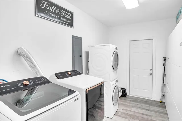 a utility room with sink dryer and washer
