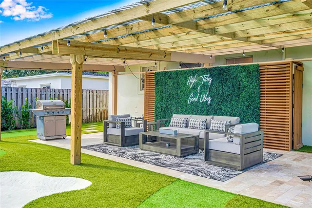 a view of a patio with table and chairs and potted plants